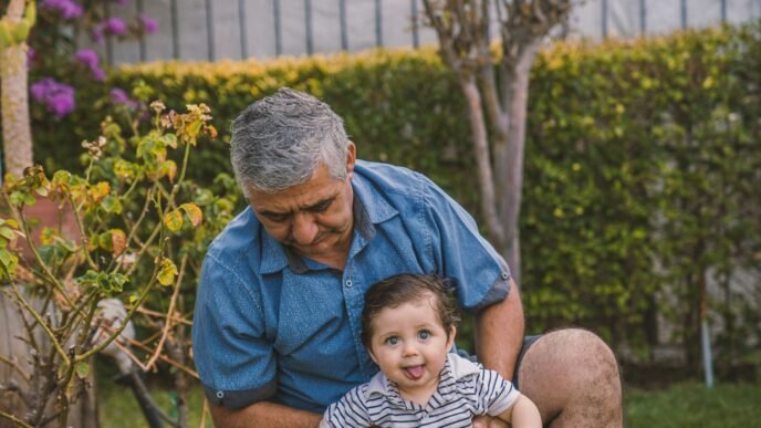 man in blue button up shirt carrying baby in black and white stripe shirt